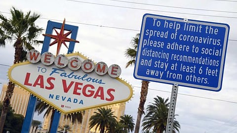 FILE PHOTO: A message on a sign placed in front of the Welcome to Fabulous Las Vegas sign, where tourists often line up to take photos, displays a message about social distancing due to the continuing spread of the coronavirus across the United States on March 22, 2020 in Las Vegas, Nevada.