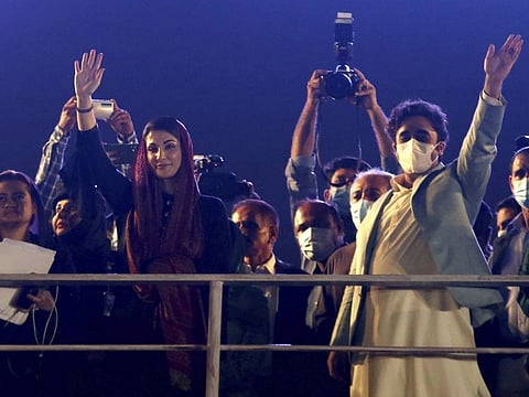 Leaders of opposition party 'Pakistan Democratic Movement' Maryam Nawaz, second left, and Bilawal Bhutto Zardari, right, wave to the masses as they arrive to attend an anti government rally, in Karachi, Pakistan, Sunday, Oct. 18, 2020