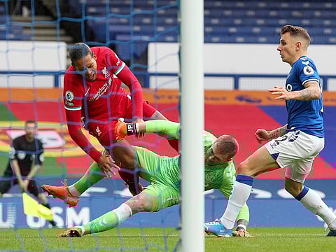 Virgil van Dijk is clobbered by Everton's Jordan Pickford