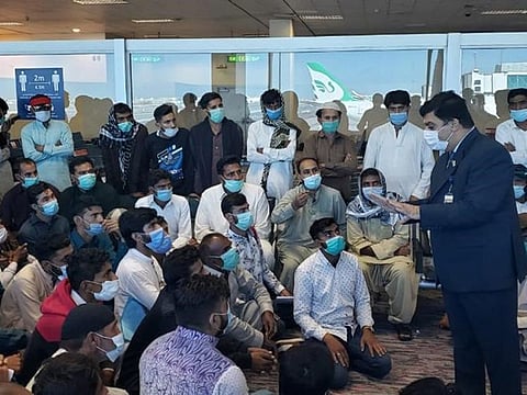 Pakistan Consul General in Dubai Ahmed Amjad Ali talking to stranded Pakistani passengers at the Dubai International Airport. The consulate has warned job seekers not to travel to Dubai on tourist visas.
