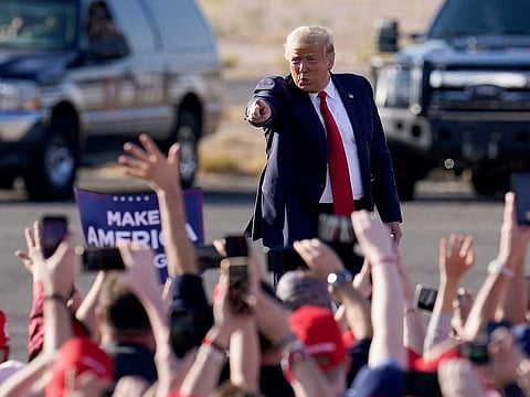 President Donald Trump waves to a cheering crowd as he arrives for a campaign rally Monday, Oct. 19, 2020, in Tucson, Ariz.