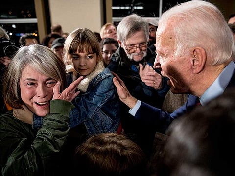In this Jan. 5, 2020, file photo, Rose Boehle of Davenport, Iowa, becomes emotional as she and one of her granddaughters, Maddie, 7, speak with Democratic presidential candidate, former Vice President Joe Biden at a campaign rally at Modern Woodmen Park in Davenport, Iowa.