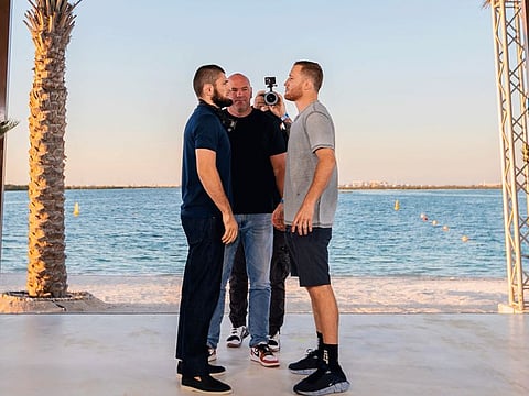 Khabib Nurmagomedov (left) and Justin Gaethje size each other up with UFC president Dana White looking on at Yas Beach today.