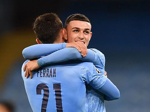 Manchester City's Ferran Torres and Phil Foden celebrate.