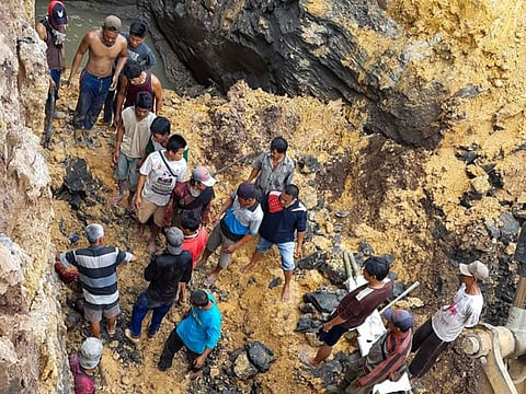 This handout pic taken and released on October 22, 2020 by local disaster mitigation agency (BPBD) shows villagers trying to evacuate the victims from about 20 metres underground at an unlicensed coal mine, in Muara Enim regency, in South Sumatra province, following a landslide triggered by heavy rain a day before killing 11 miners.