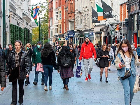 Shoppers walk through a busy Grafton Street in Dublin. Ireland's finance ministry expects to lose two billion euros ($2.4 billion) each year from 2025 if the global minimum rate comes about.