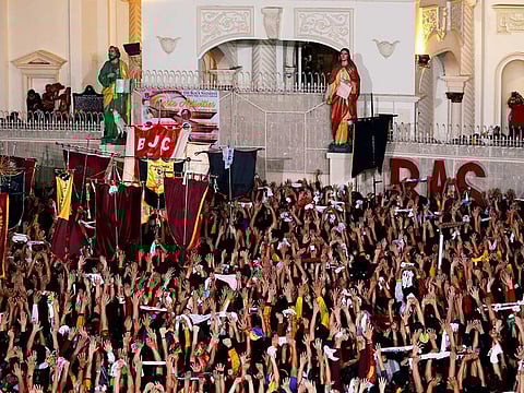 Filipino devotees raise their hands after the statue of the Black Nazarene arrives at Quiapo Church during its feast day in Manila, Philippines January 9, 2020.