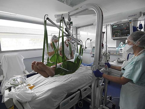 Medical staff tend to a patient at a level intensive care unit for patients infected with COVID-19 at the University Hospital of Strasbourg (HUS) in Strasbourg, eastern France on October 22, 2020.