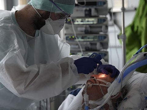 Medical staff tend to a patient at a level intensive care unit for patients infected with Covid-19 (novel coronavirus) at the University Hospital of Strasbourg (HUS) in Strasbourg, eastern France on October 22, 2020