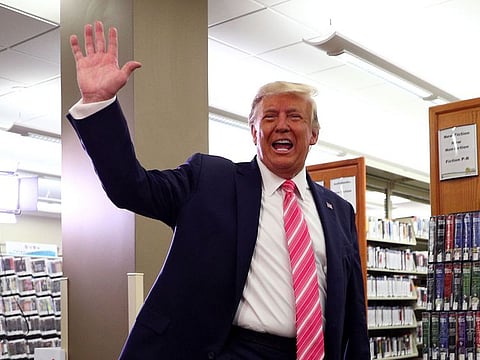US President Donald Trump waves after voting in the 2020 presidential election at the Palm Beach County Library in West Palm Beach.