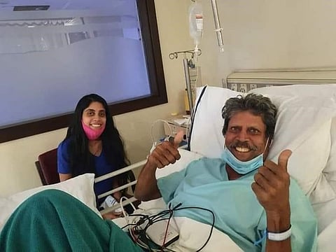Kapil Dev gives the thumbs up from his hospital bed alongside daughter Amiya.