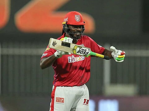 Chris Gayle of Kings XI Punjab raises his bat after scoring a fifty.