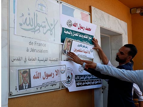 Arabic reads: "Despite Macron's malice, we rise up to our Prophet" and referring to criticism, "Anything but God's messenger."
