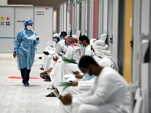 People sit as they wait their turn for vaccine trials at Abu Dhabi National Exhibition Center in Abu Dhabi, United Arab Emirates.Reuters