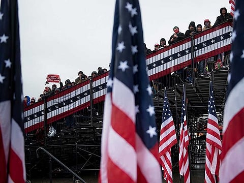 People wait for US President Donald Trump during a Make America Great Again rally at Capital Region International Airport October 27, 2020, in Lansing, Michigan.