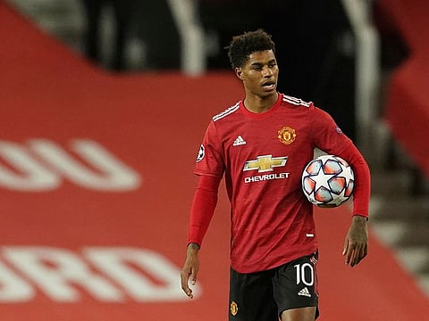 Manchester United's Marcus Rashford with the match ball after netting a hat-trick.