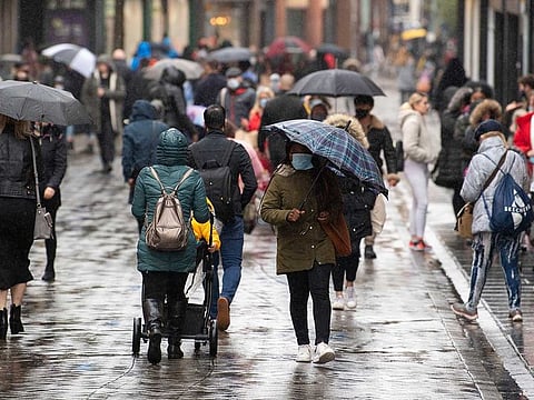 Many people wearing face masks as they move along a main shopping street in Nottingham, England.