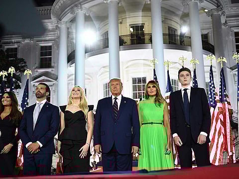 In this file photo taken on August 27, 2020 (R-L) Barron Trump, US First Lady Melania Trump, US President Donald Trump, Tiffany Trump, Donald Trump Jr. and Kimberly Guilfoyle watch fireworks at the conclusion of the final day of the Republican National Convention from the South Lawn of the White House in Washington, DC.