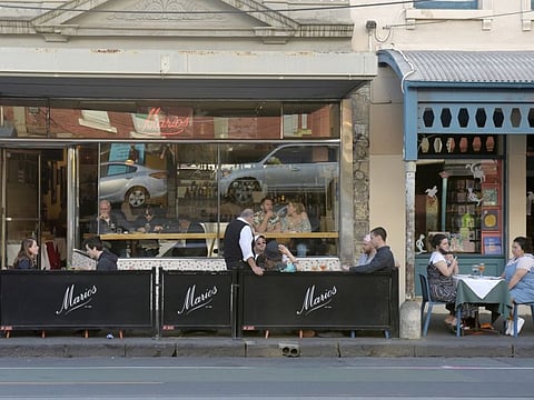 Customers sit at socially distanced tables outside a restaurant in the Fitzroy suburb of Melbourne, Australia, on Wednesday, October 28, 2020.