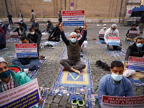 Members of an Italian Muslim group protest against the offensive cartoons in Rome on October 30.