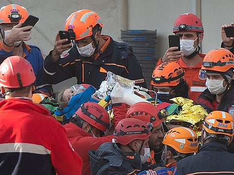 Rescue workers carry four-year-old girl Ayda Gezgin as they pull her out of the rubble of a building 91 hours after it collapsed during a 7.0-magnitude earthquake, at Bayrakli district in Izmir, on November 3, 2020. -