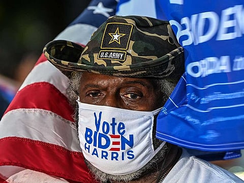 People attend a drive-in rally with former US President Barack Obama as he campaigns for Democratic presidential candidate former Vice President Joe Biden in Miami, Florida on November 2, 2020.