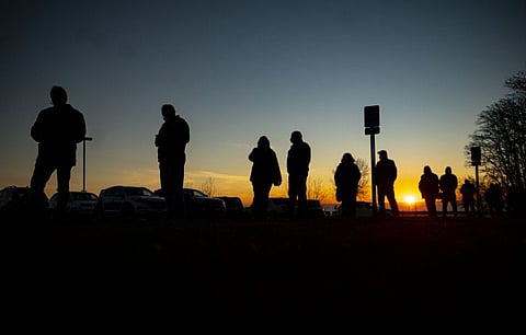 A long line of voters formed outside of First United Methodist Church as the sun rose over Lake Superior in Duluth on Tuesday morning