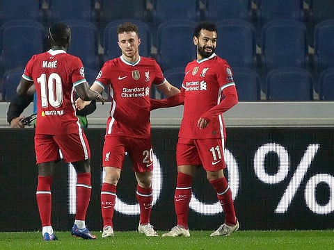 Liverpool's Diogo Jota, center, celebrates with his teammate Mohamed Salah, right, and Sadio Mane.AP