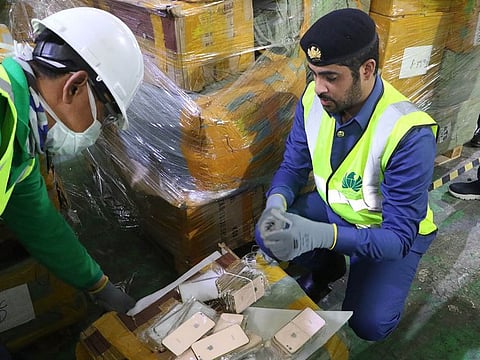 Customs officials check the seized fake items.