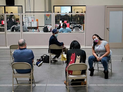 Observers watch as county election workers scan mail-in ballots at a tabulating area at the Clark County Election Department, Thursday, Nov. 5, 2020, in Las Vegas.