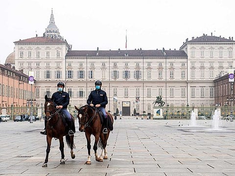 Mounted police walk across Turin's Piazza Castello, northern Italy, Friday, Nov. 6, 2020. Piedmont is among the four Italian regions classified as red zones in the fight against COVID-19, where a strict lockdown was imposed starting Friday.
