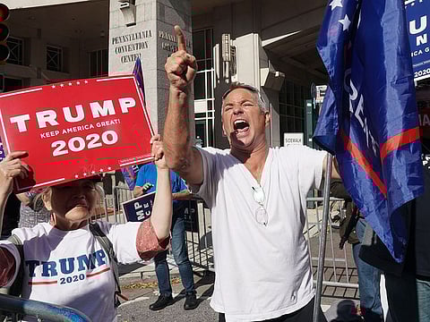 A Trump supporter screams outside the Pennsylvania Convention Center as ballot counting inside, in Philadelphia.
