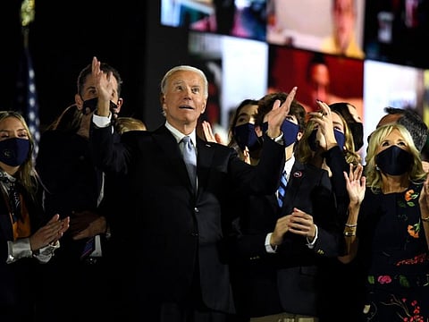 US President-elect Joe Biden with his wife Jill Biden, alongside family members, salute the crowd on stage after delivering remarks in Wilmington, Delaware, on November 7, 2020, and being declared the winner of the US presidential election