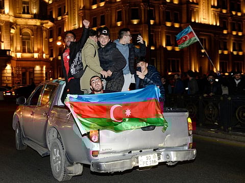 Azerbaijanis celebrate in the streets of Baku on November 10, 2020. Armenia and Azerbaijan agreed on a deal with Russia to end weeks of fierce clashes over Nagorno-Karabakh on Tuesday, after a string of Azerbaijani victories in its fight to retake the disputed region.