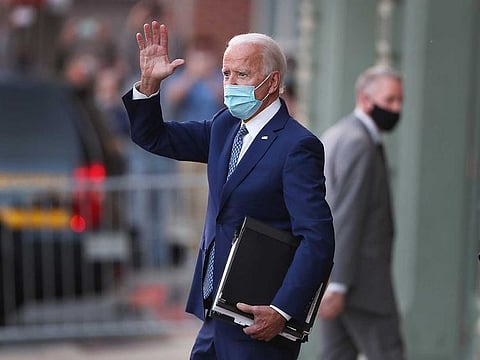 President-elect Joe Biden waves to supporters as he leaves the Queen theatre after receiving a briefing from the transition COVID-19 advisory board on November 09, 2020 in Wilmington, Delaware.