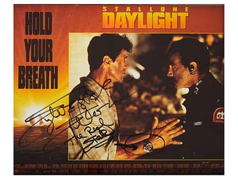 A lobby card of the 1996 film signed by Stallone shows him wearing the watch