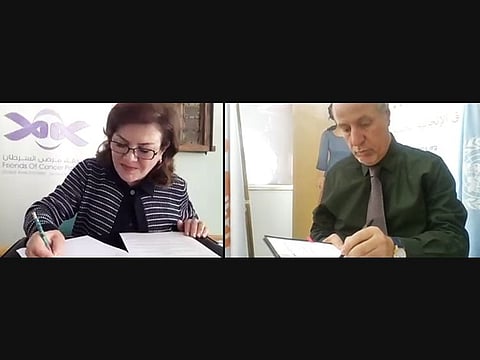 Sawsan Jafar and Dr. Luay Shabaneh sign the agreement.