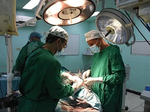 The operation in progress to remove the nails and glass.