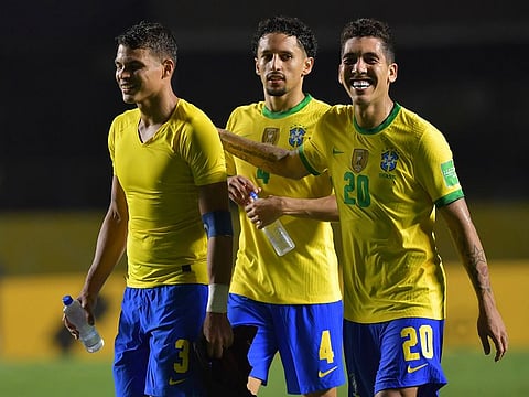 Brazil's Roberto Firmino, right, Marquinhos, and Brazil's Thiago Silva