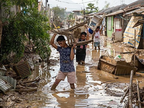 Residents retrieve belongings from their submerged village following floods caused by Typhoon Vamco, in Rodriguez, Rizal province, Philippines, November 14, 2020.