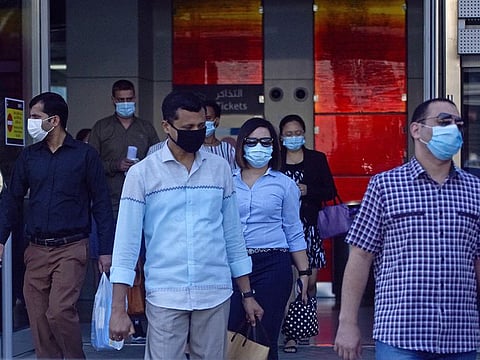 Dubai residents in protective face masks.