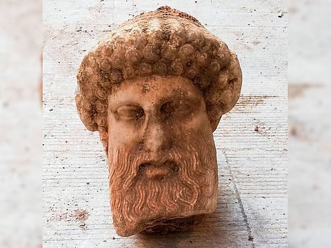 The head of an ancient statue of the Greek god Hermes, in Athens, which has been unearthed during excavations for sewage system improvements in central Athens, the ministry of culture said