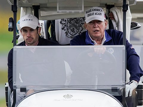 US President Donald Trump drives a golf cart at the Trump National Golf Club in Sterling, Virginia, US, November 15, 2020.