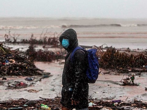 A man walks at the beach in El Muelle neighbourhood in Bilwi, Puerto Cabezas, Nicaragua, on November 16, 2020 as Hurricane Iota - upgraded to Category 5 - moves over the Caribbean towards the Nicaragua-Honduras border. AFP