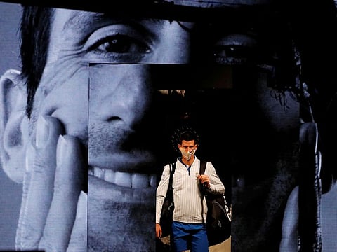 World No.1 Novak Djokovic walks out with a face mask ahead of his group stage match against Argentina's Diego Schwartzman on Monday evening.