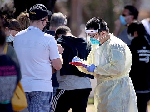 A medical staff member takes details from people queuing at a coronavirus disease (COVID-19) testing site as the state of South Australia experiences an outbreak, in Adelaide, Australia, November 17, 2020.