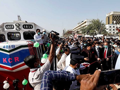 Pakistan's Railways Minister Sheikh Rasheed Ahmed cuts the ribbon as he inaugurates the Karachi Circular Railway (KCR) inner-city train service, which was discontinued in 1999, at a city station in Karachi, Pakistan November 19, 2020.