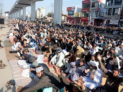 Activists and supporters of Tehreek-e-Labbaik Pakistan (TLP) gather outside the house of Khadim Hussain Rizvi, founder of TLP, a day after his death, in Lahore on November 20, 2020.