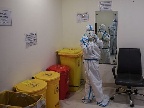 A medical staff is seen inside a doffing room after finishing a shift inside the coronavirus wing of Max Hospital in New Delhi on November 21, 2020.