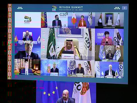 European Council President Charles Michel, Saudi Arabia's King Salman and other leaders are seen on a screen before the start of the virtual G20 meeting hosted by Saudi Arabia, amid the coronavirus outbreak.